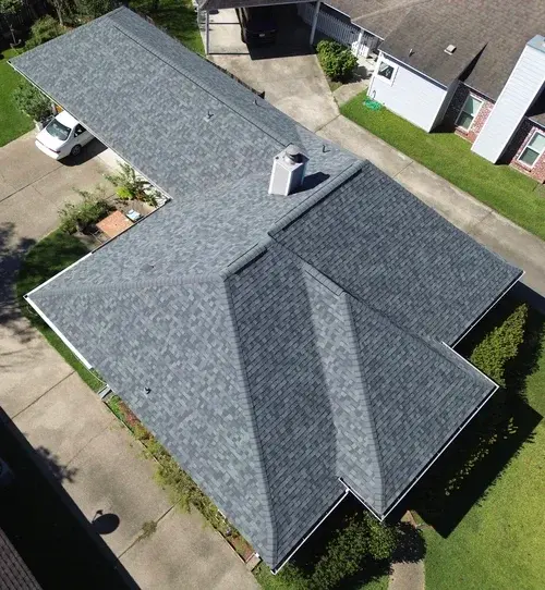 Top-down drone aerial of an immaculate multi-hip shingle roof