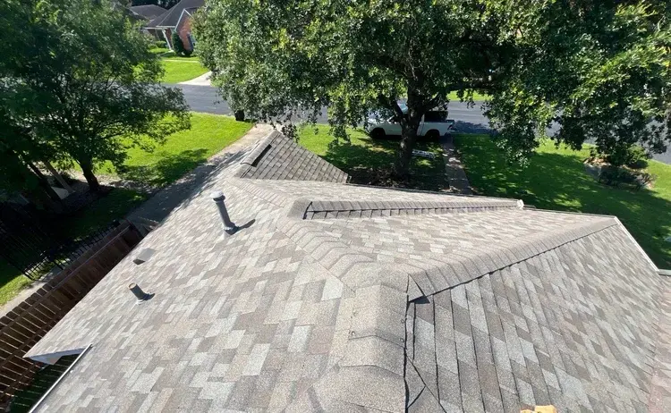 View from on top of a freshly installed shingle roof looking across to the street
